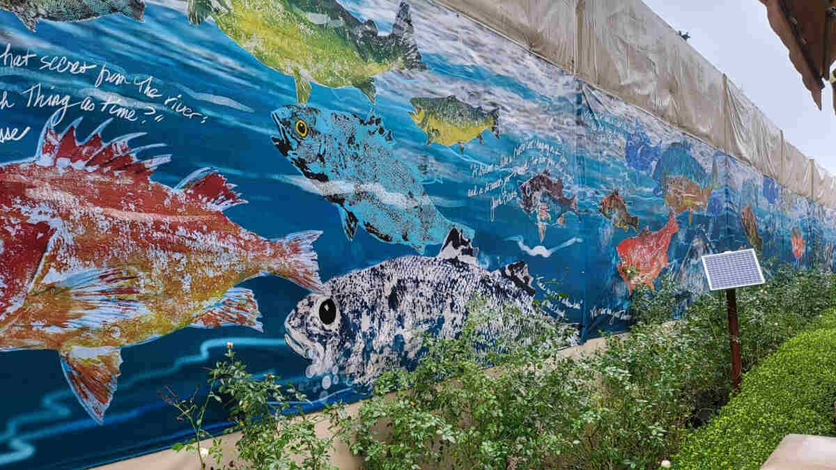 Custom art mural wrap on a noise barrier. 